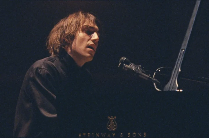 Cameron Winter singing at a Steinway grand piano in Cameron Winter at Carnegie Hall